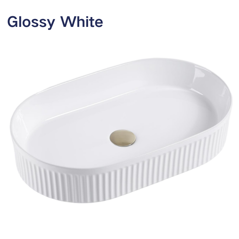 Glossy white oval fluted ceramic vessel sink with ribbed exterior for modern bathroom vanities.