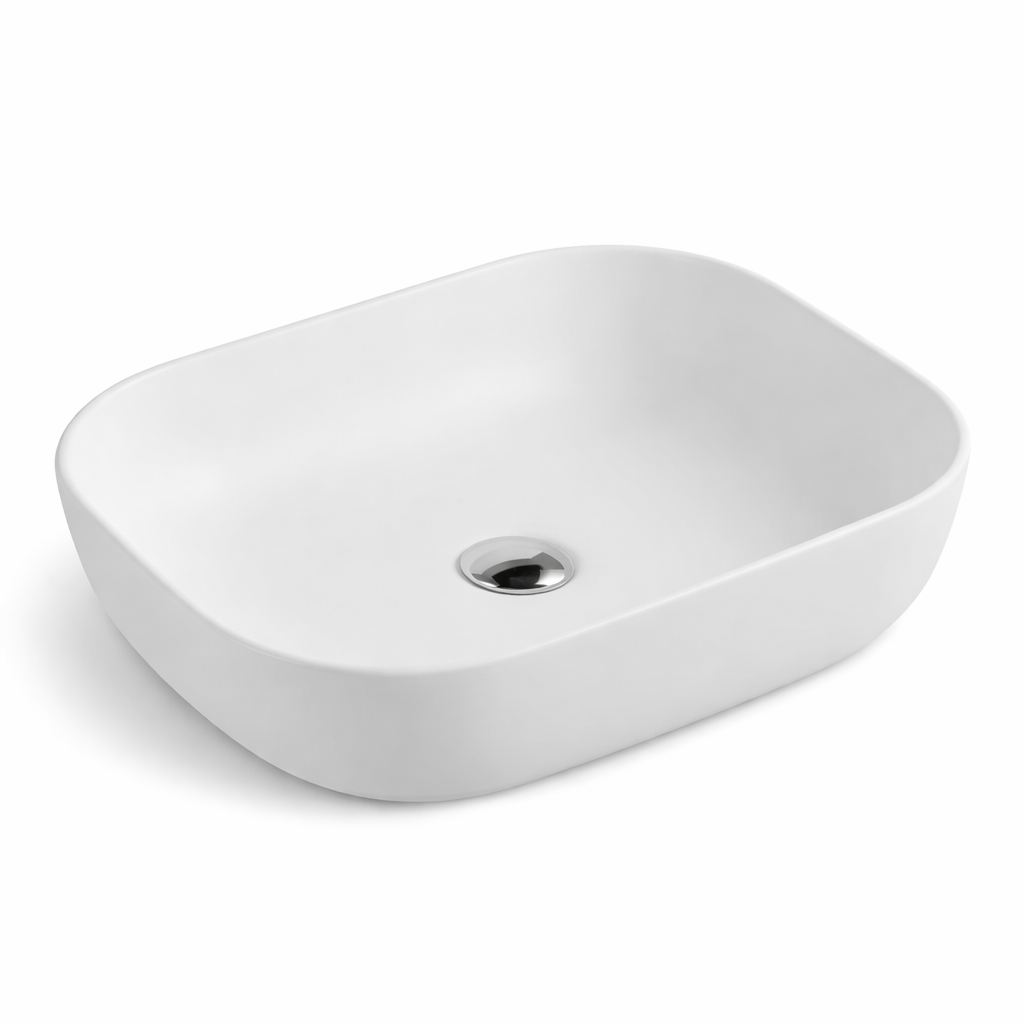 Modern matte white rectangular vessel bathroom sink with rounded corners and a polished chrome drain.