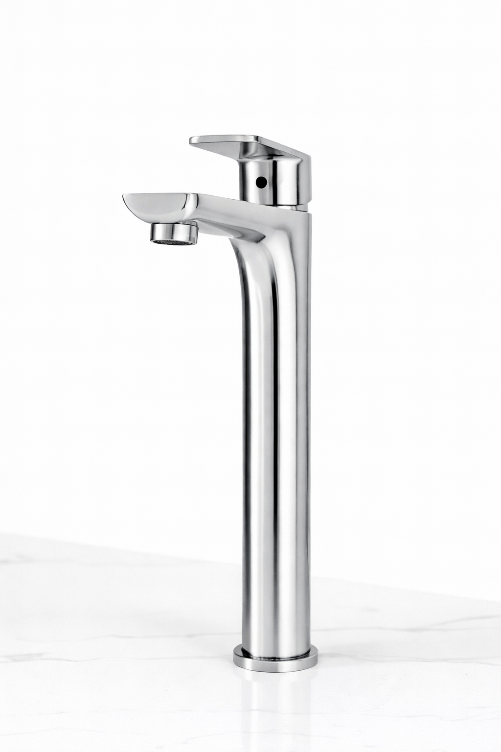 Tall polished chrome single-handle bathroom vessel faucet on a white marble countertop.