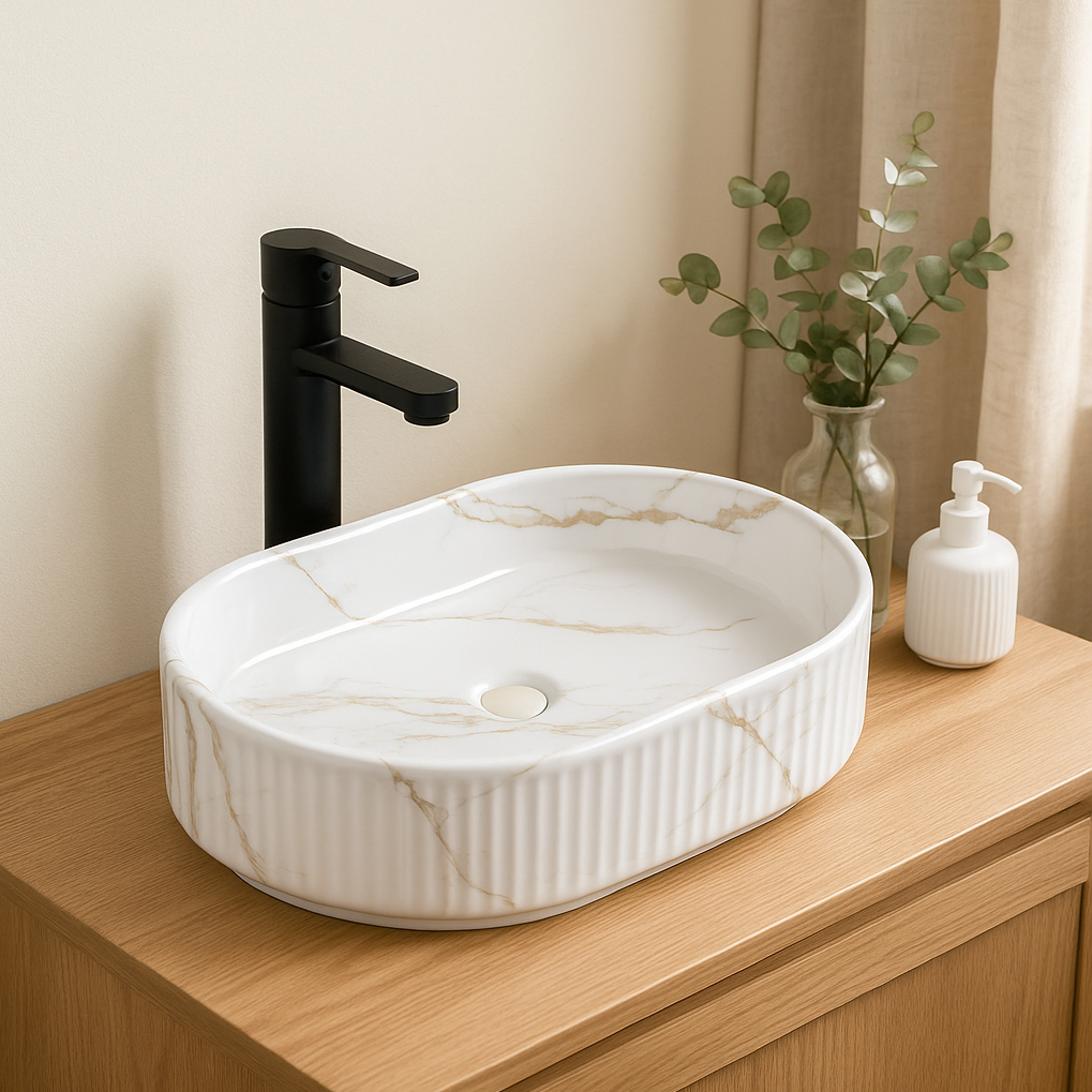 Modern oval fluted white marble vessel sink with gold veining, matte black faucet, and wood bathroom vanity.