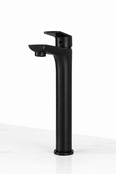 Modern matte black tall vessel bathroom faucet with single handle on white marble.