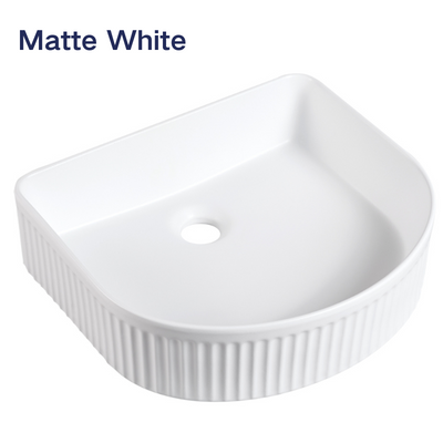 Matte white fluted vessel sink with a D-shape design and ribbed texture for modern bathroom vanities.