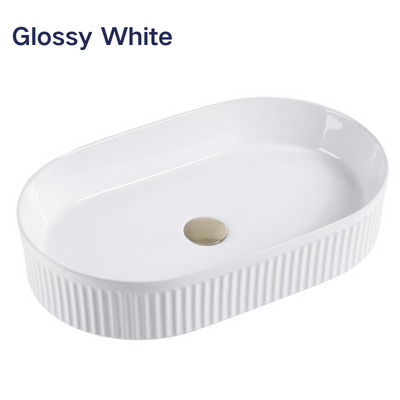 Glossy white oval fluted ceramic vessel sink with ribbed exterior for modern bathroom vanities.
