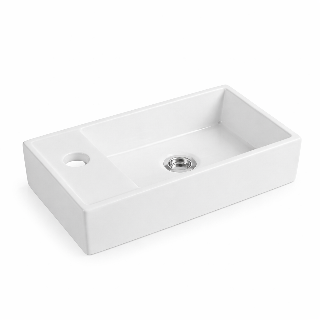Modern white rectangular ceramic vessel sink with single faucet hole and chrome drain assembly.