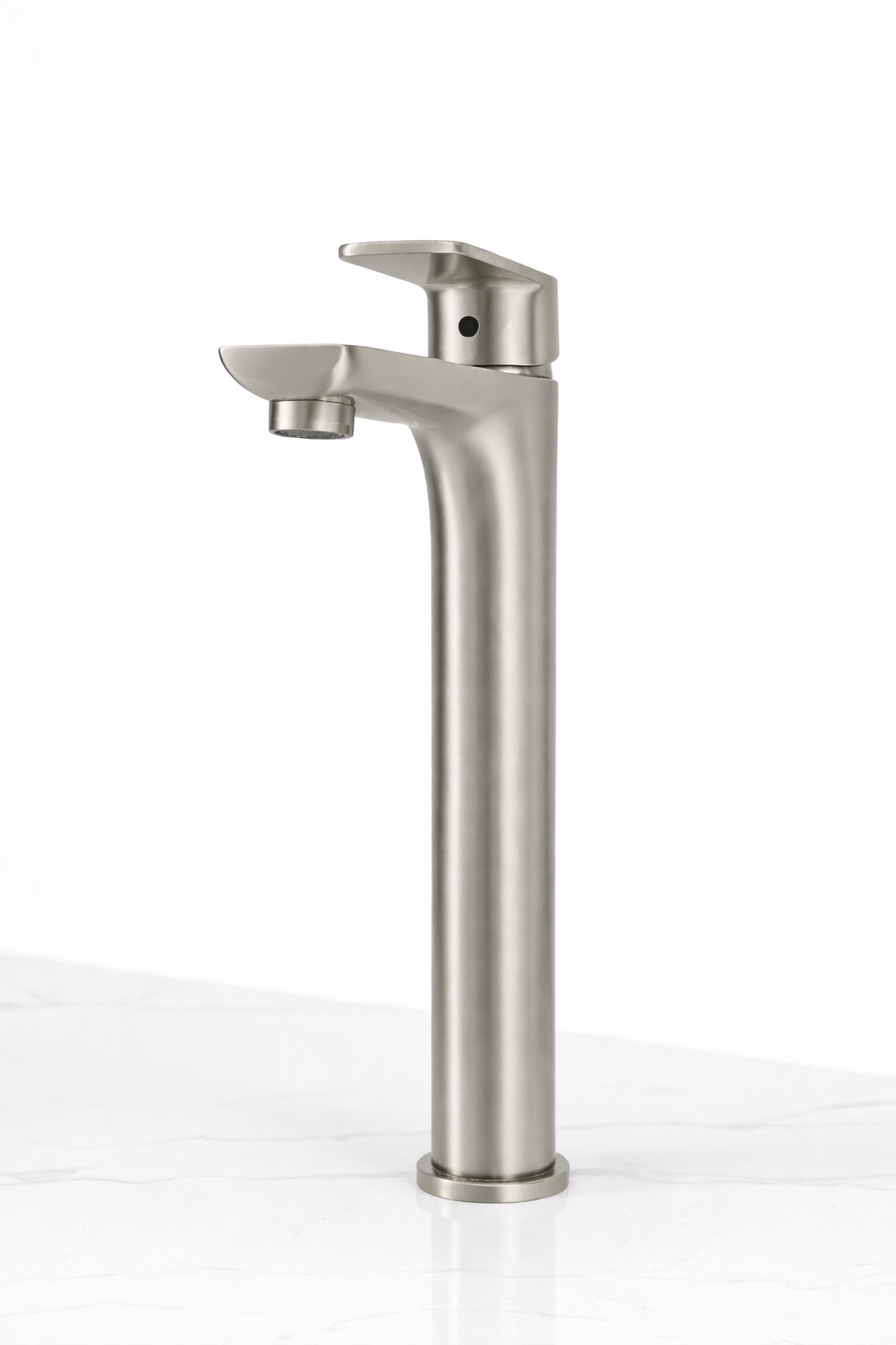 Modern brushed nickel single-handle tall vessel bathroom faucet on white marble countertop.