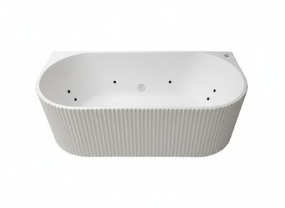 Modern white whirlpool bathtub with fluted exterior, back-to-wall design, and integrated massage jets.