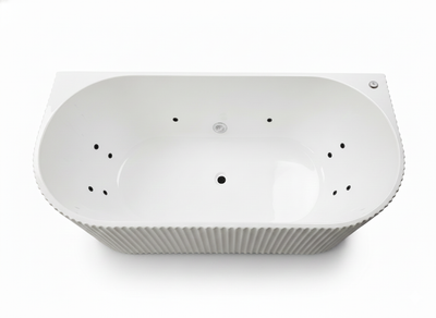 White oval whirlpool bathtub with fluted exterior and integrated massage jets for a luxury bathroom.