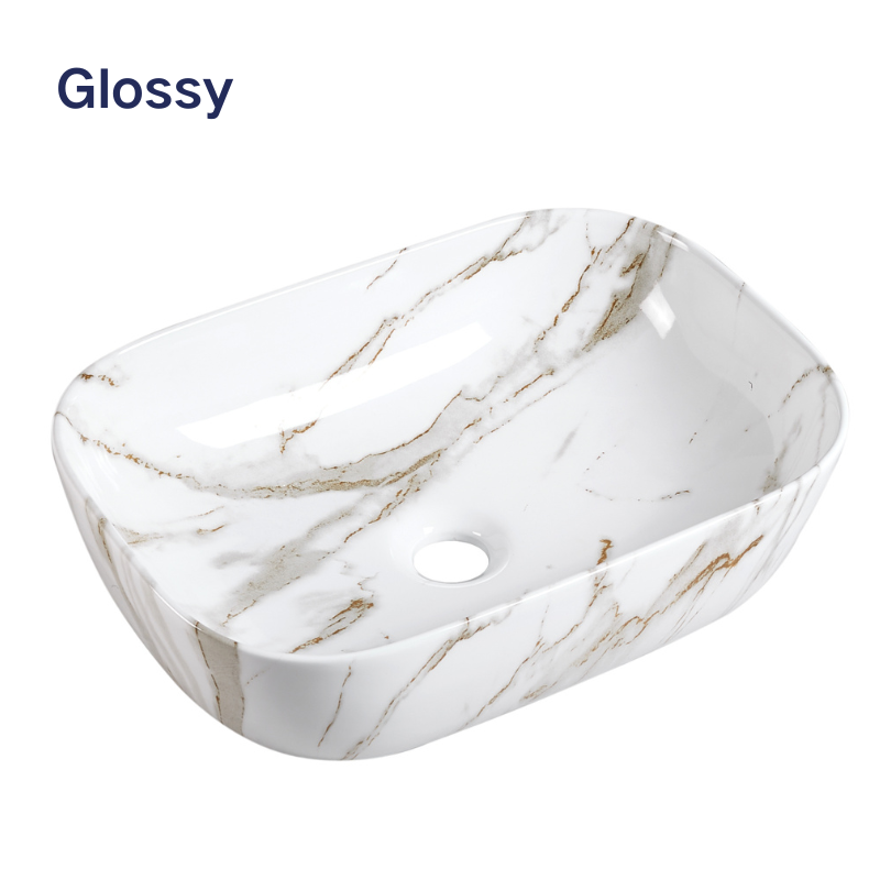 Glossy white marble rectangular vessel sink with gold veining, modern above-counter ceramic bathroom basin.