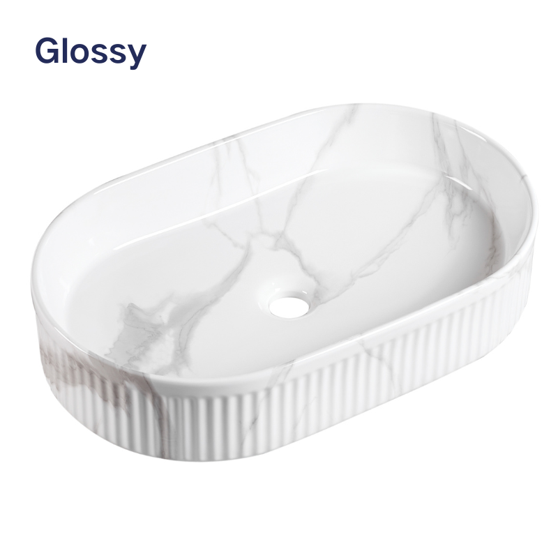 Glossy white marble oval vessel sink with ribbed textured exterior for bathroom vanity.