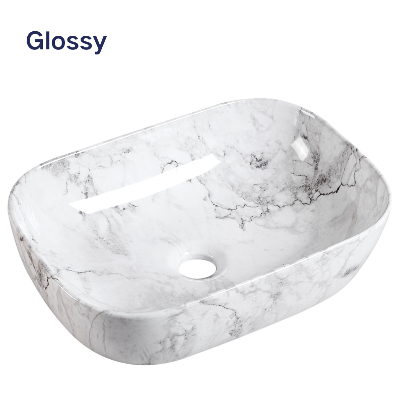 Glossy white marble rectangular vessel sink with rounded edges for bathroom countertop installation.