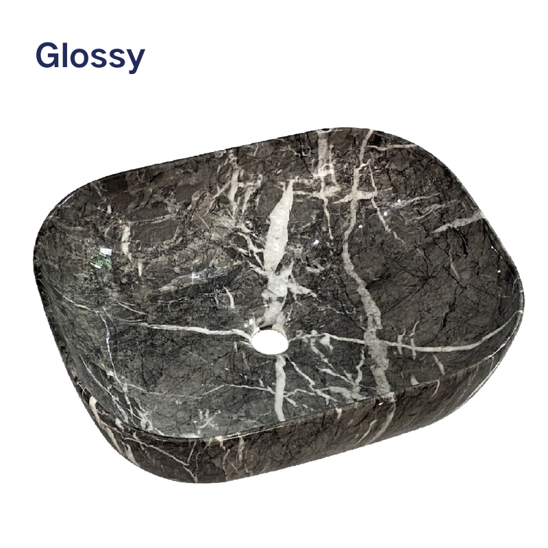 Glossy dark marble vessel sink with white veining, rectangular bathroom basin with rounded edges.