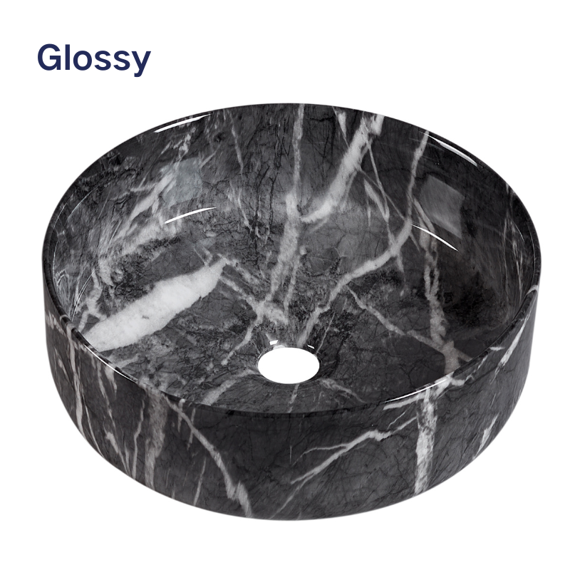 Glossy black and white marble round vessel sink for modern bathroom vanity.