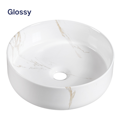 Glossy white round ceramic vessel sink with gold marble veining for bathroom.