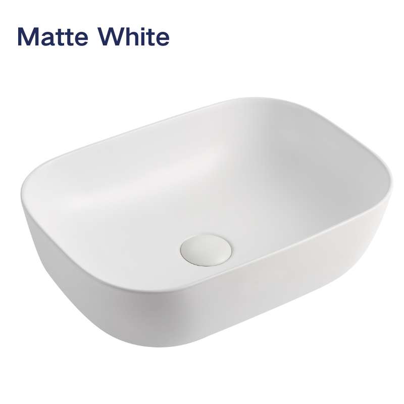 Modern matte white rectangular vessel bathroom sink with rounded edges.