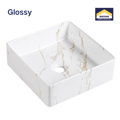 Glossy white square ceramic vessel sink with gold marble veining for modern bathroom vanities.