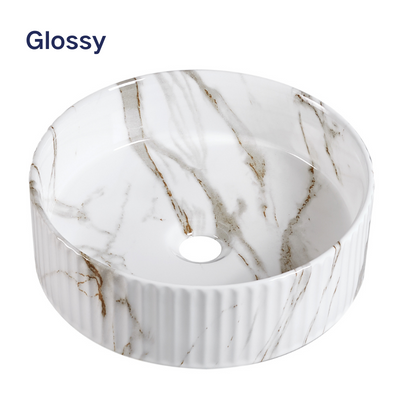 Glossy white marble fluted round vessel sink with gold veins for modern bathroom vanity decor.
