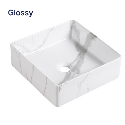 Glossy white square ceramic vessel sink with gray marble pattern for bathroom vanity.