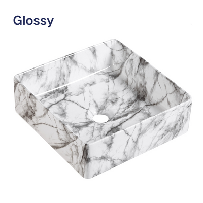 Modern square vessel bathroom sink with glossy white and grey marble pattern.