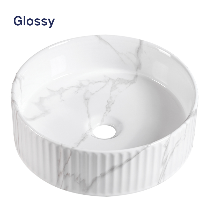 Glossy white marble vessel sink with round fluted design for modern bathroom countertop.