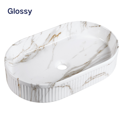 Glossy white marble-effect oval vessel sink with gold veining and a fluted exterior for bathroom vanities.