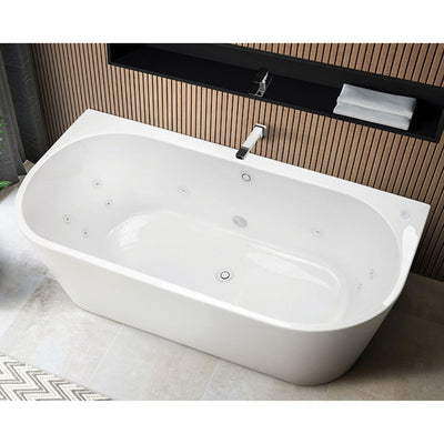 White jetted whirlpool bathtub with chrome faucet in a modern bathroom with wood-slat wall accents.