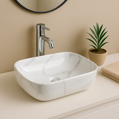 Modern white marble rectangular vessel sink with chrome faucet on a beige bathroom vanity.