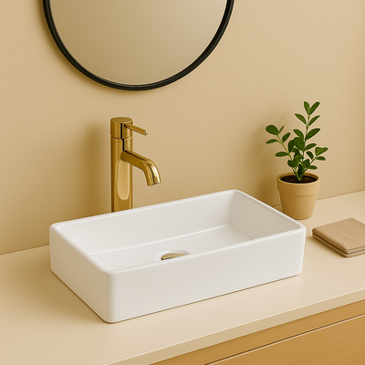 Modern white ceramic rectangular vessel sink with a polished gold faucet in a minimalist bathroom.