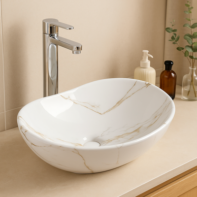 White marble vessel sink with gold veining and tall chrome faucet on a modern beige bathroom vanity.