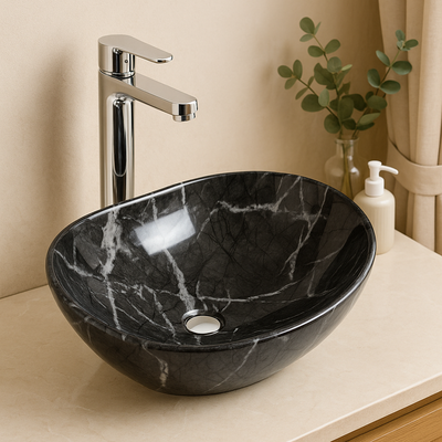 Modern black marble vessel sink with white veins and chrome faucet on a beige bathroom vanity.